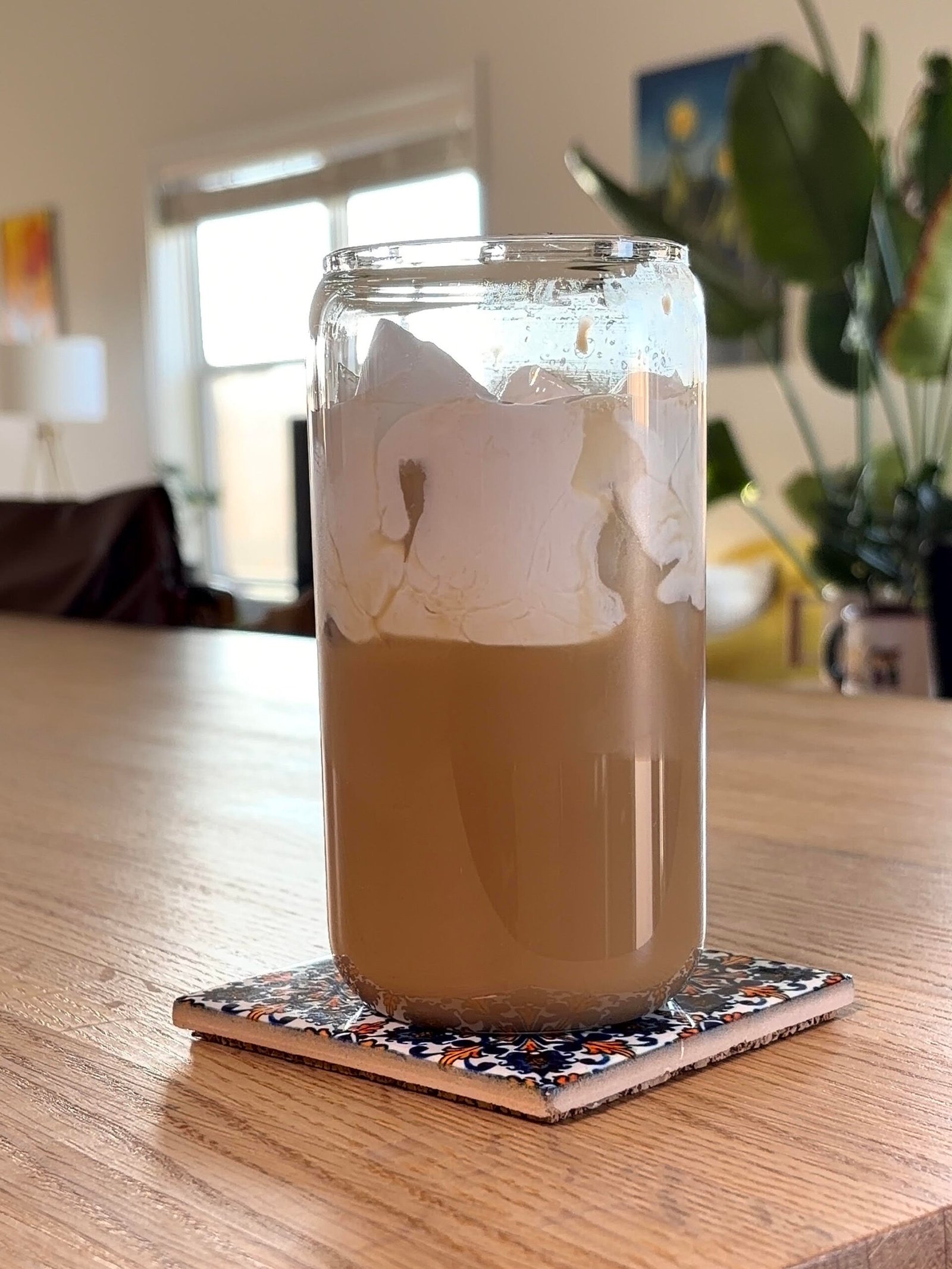 Vietnamese coconut iced coffee topped with coconut cream in a glass